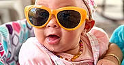 Brynlii joined the competition — help win amazing prizes! accessory, arm, baby, bow, child, clothing, colorful, cute, hand, headband, indoor, infant, patterned, pink, portrait, smile, sunglasses, toy, walker, yellow