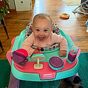 Brynlii joined the competition — help win amazing prizes! baby, cat, child, colorful, cute, floor, furniture, happy, home, indoor, infant, joyful, person, pet, playful, seat, smiling, toy, walker, wooden_floor