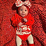 baby, infant, red_clothing, headband, bow, blanket, knit, smiling, white_shoes, tights, cute, valentine, indoor, portrait, laying_down, happy, small_hands, cozy, fabric, child