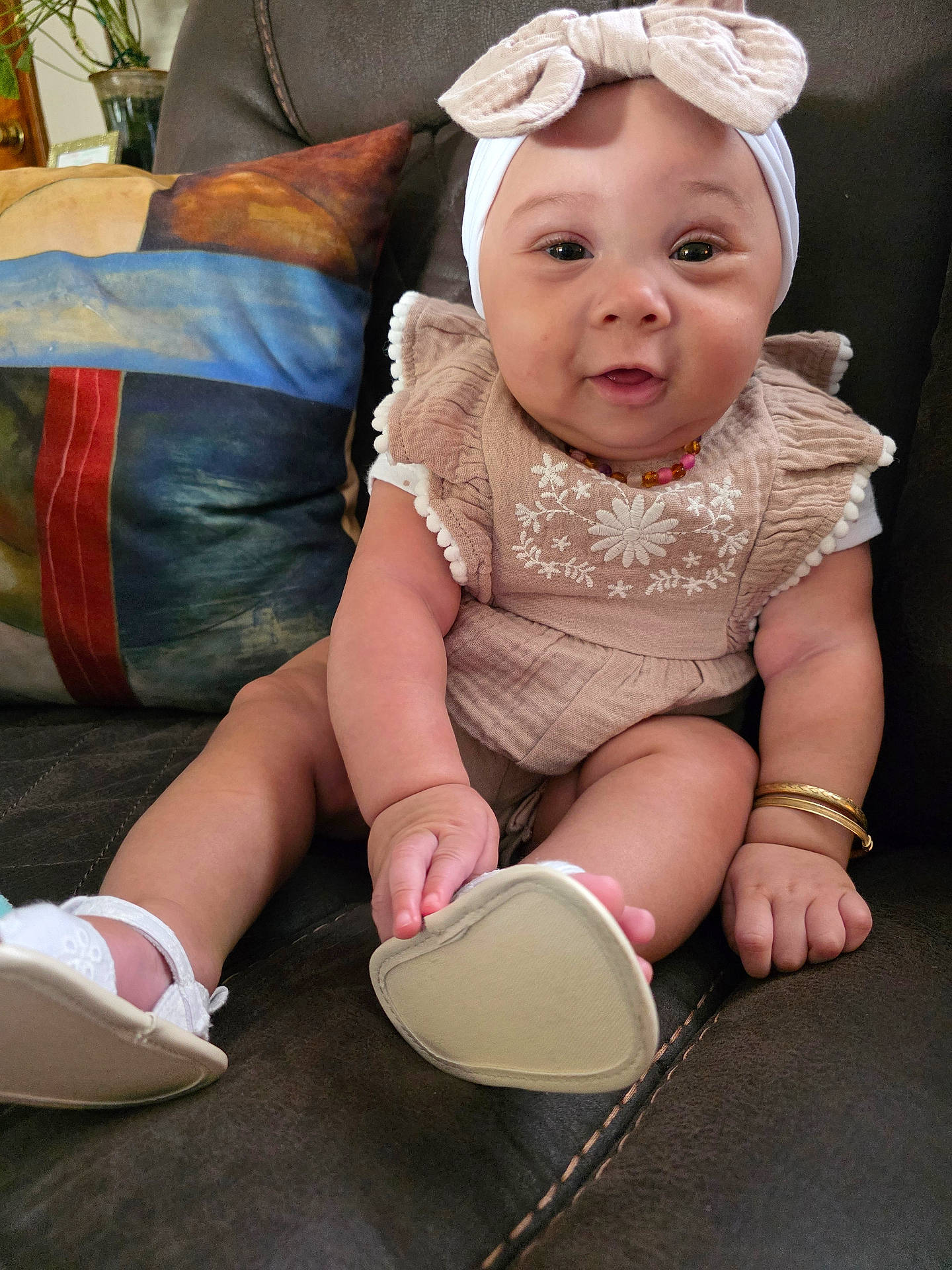 Brynlii joined the competition — help win amazing prizes! baby, bow, bracelet, child, clothing, couch, cute, decor, face, footwear, hand, headband, home, infant, leather, pillow, portrait, shoe, sitting, smile