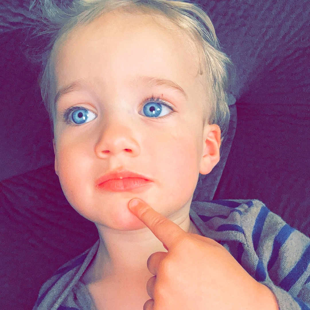 Maverick is registered to the contest to win money with this photo: baby, blonde, bodypart, clothing, cosmetics, couch, face, finger, furniture, hair, hand, happy, head, lipstick, person, photography, portrait, smile, t_shirt, wrist