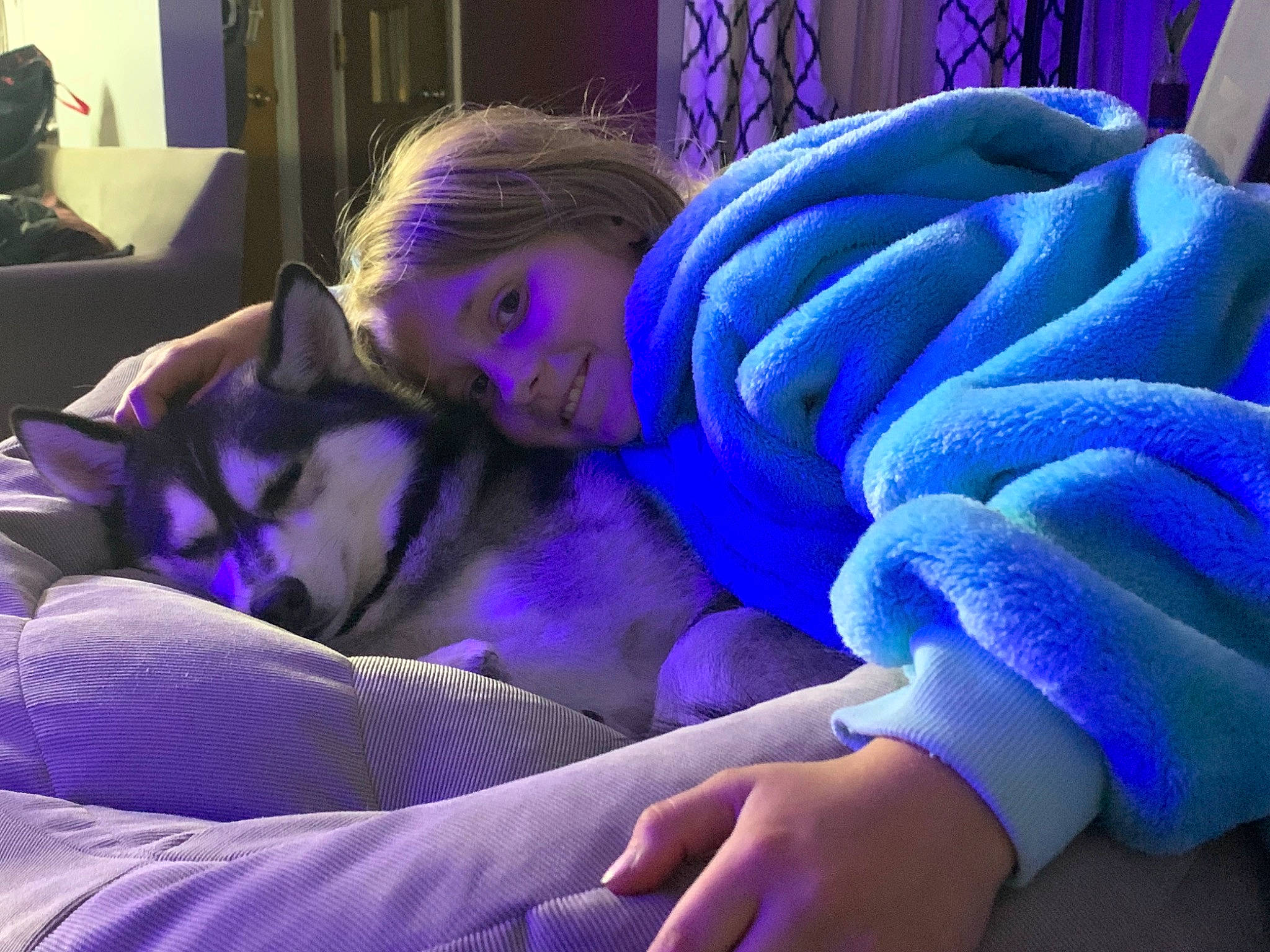 Peyton is registered to the contest to win money with this photo: abdomen, blue, child, comfort, elbow, electric_blue, finger, fun, gesture, hand, human_body, human_leg, joy, lap, magenta, nail, person, purple, thigh, thumb