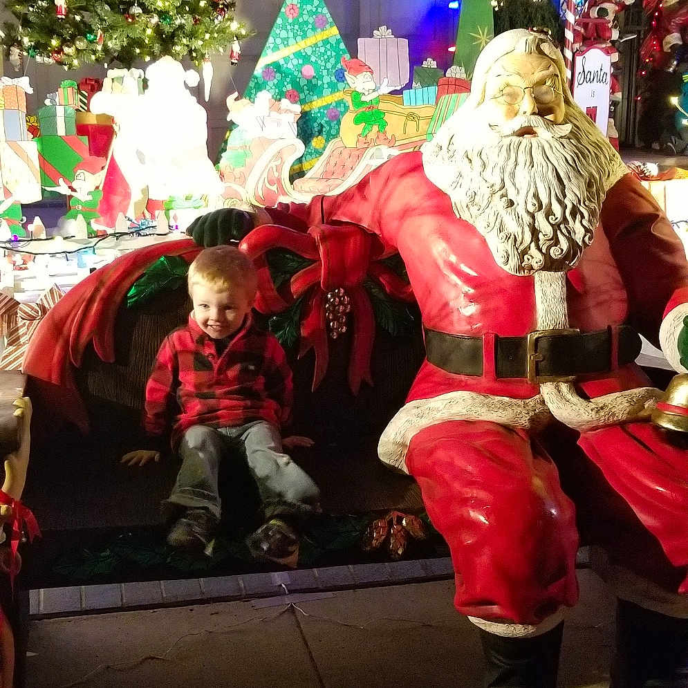 Zane is registered to the contest to win money with this photo: christmas, christmas_decoration, event, festival, fete, fictional_character, fun, holiday, joy, person, santa_claus, tradition
