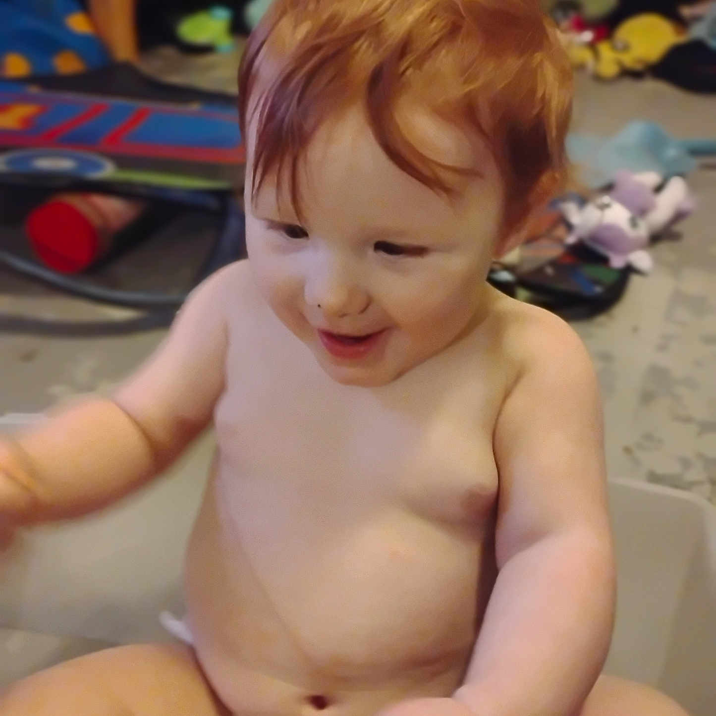 Nevaeh joined the competition — help win amazing prizes! baby, child, diaper, red_hair, smiling, sitting, indoor, toy, clutter, floor, skin, happy, infant, person, cute, young_child, expression, playful, chubby, room