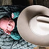 baby, blanket, child, closeup, cowboy_hat, cozy, cute, face, hand, hat, indoors, infant, knit, newborn, peaceful, portrait, resting, sleeping, soft, wooden_floor