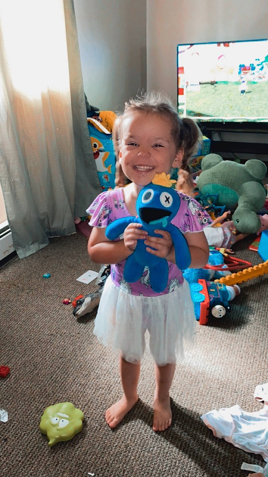 Kaylani is registered to the contest to win money with this photo: baby, baby_toddler_clothing, child, curtain, event, flooring, fun, happy, joy, leisure, person, play, recreation, sandal, shorts, smile, stuffed_toy, summer, toddler, toy