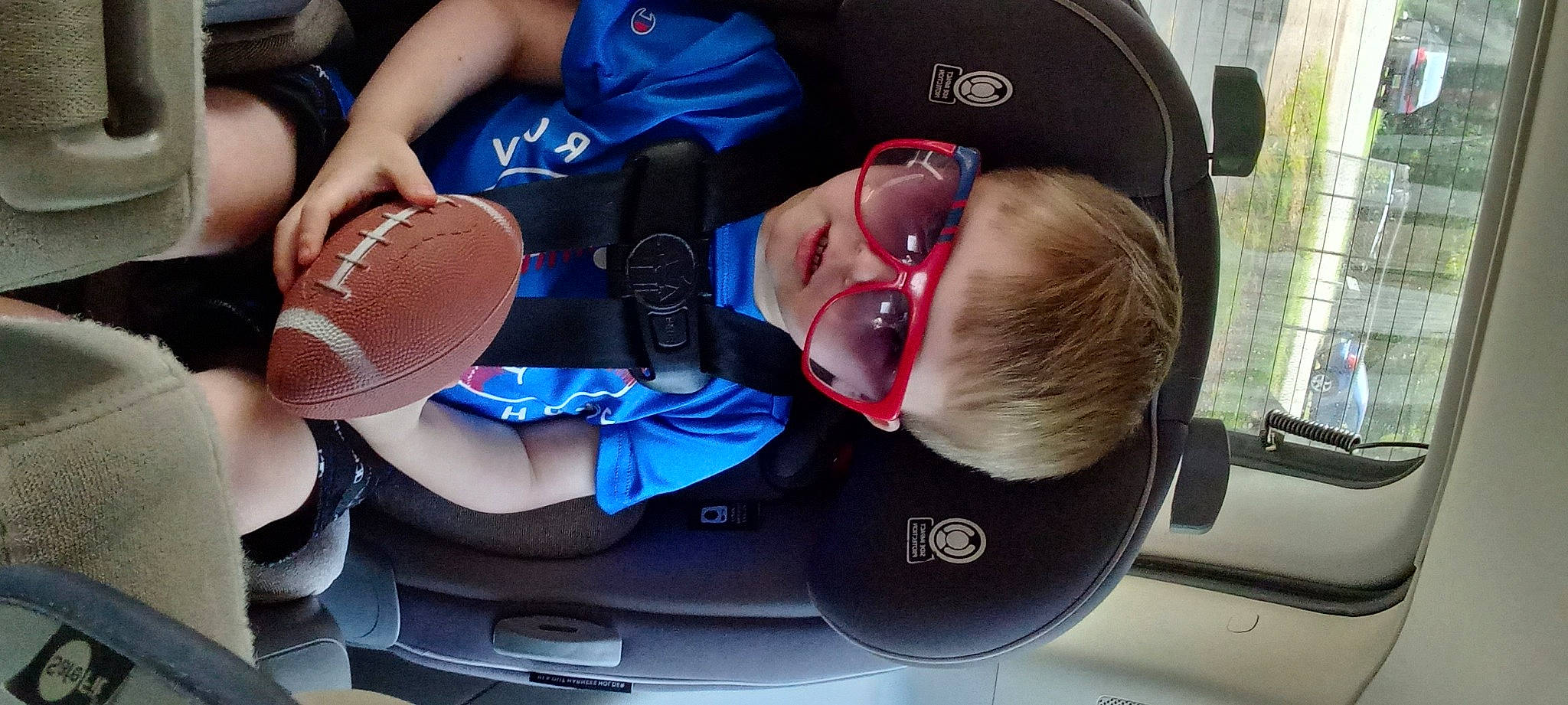 Devin is registered to the contest to win money with this photo: auto_part, automotive_design, automotive_exterior, baseball_cap, cap, car_seat, comfort, cool, elbow, eyewear, fun, gesture, hat, headgear, mouth, person, personal_protective_equipment, smile, sports_gear, sunglasses