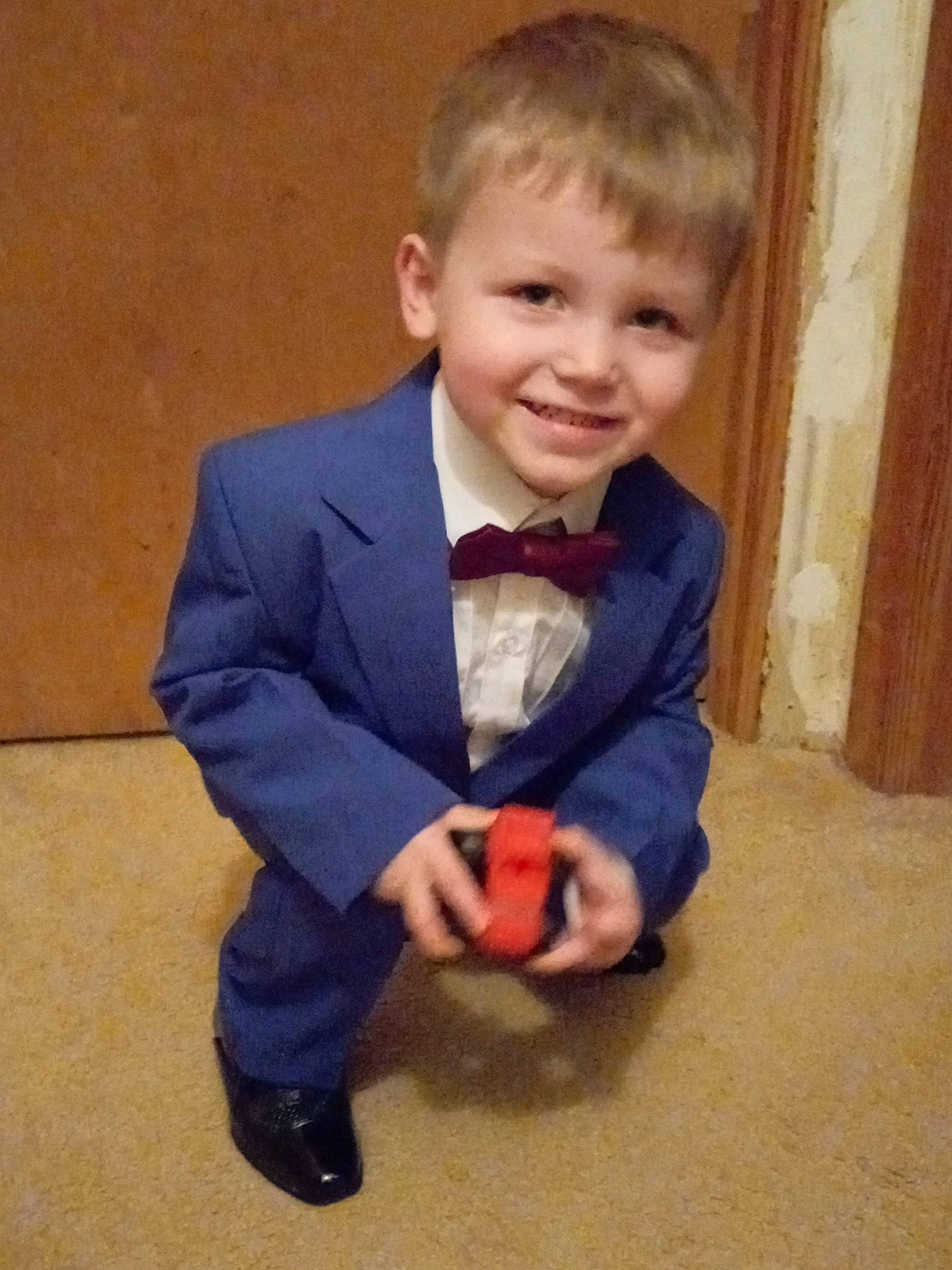 Devin is registered to the contest to win money with this photo: arm, baby_toddler_clothing, blazer, cheek, chin, collar, cool, dress_shirt, eye, face, facial_expression, flooring, formal_wear, hair, happy, human_body, joy, nose, person, sleeve