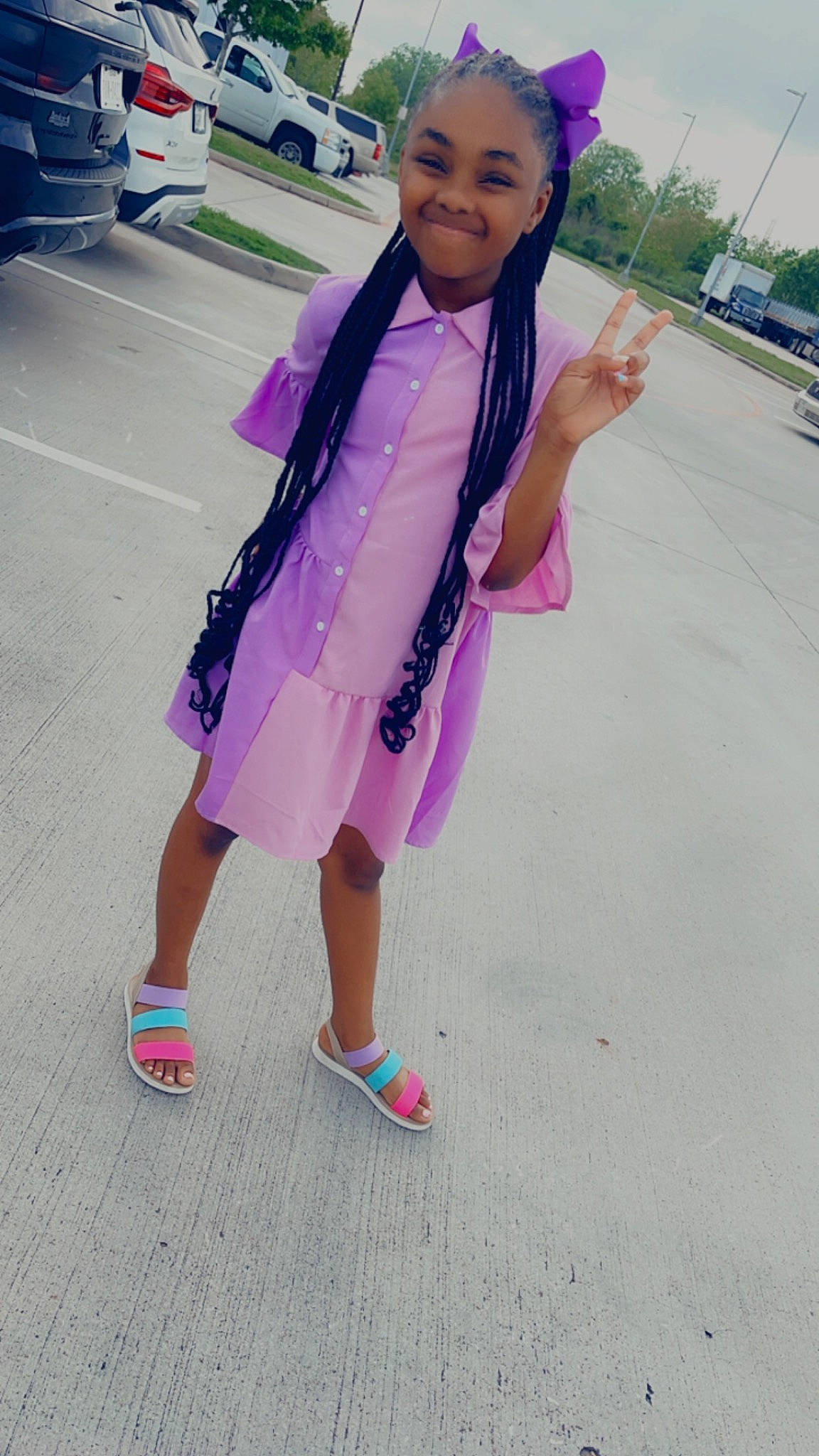 Nia is registered to the contest to win money with this photo: asphalt, costume, electric_blue, family_car, fashion_accessory, fun, happy, joy, leisure, magenta, person, pink, purple, recreation, road, sandal, smile, t_shirt, toddler, travel