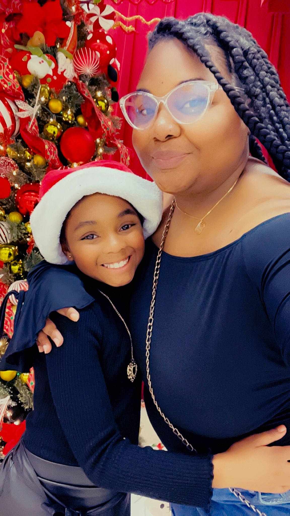 Nia is registered to the contest to win money with this photo: cap, child, christmas_ornament, event, eyewear, fashion_accessory, fun, glasses, happy, head, headgear, headwear, holiday, jewellery, joy, person, red, smile, toddler, tradition