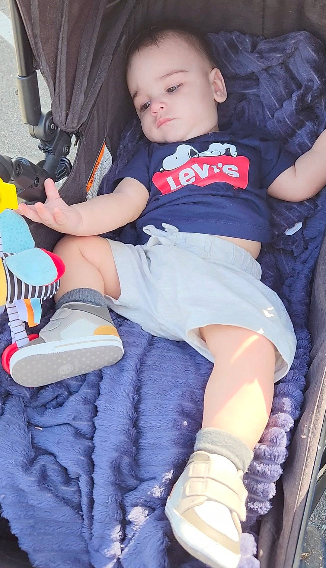 Reuben is registered to the contest to win money with this photo: baby, baby_toddler_clothing, carmine, chair, child, cool, elbow, electric_blue, finger, fun, human_leg, knee, lap, person, shorts, sitting, sneakers, sock, t_shirt, thigh