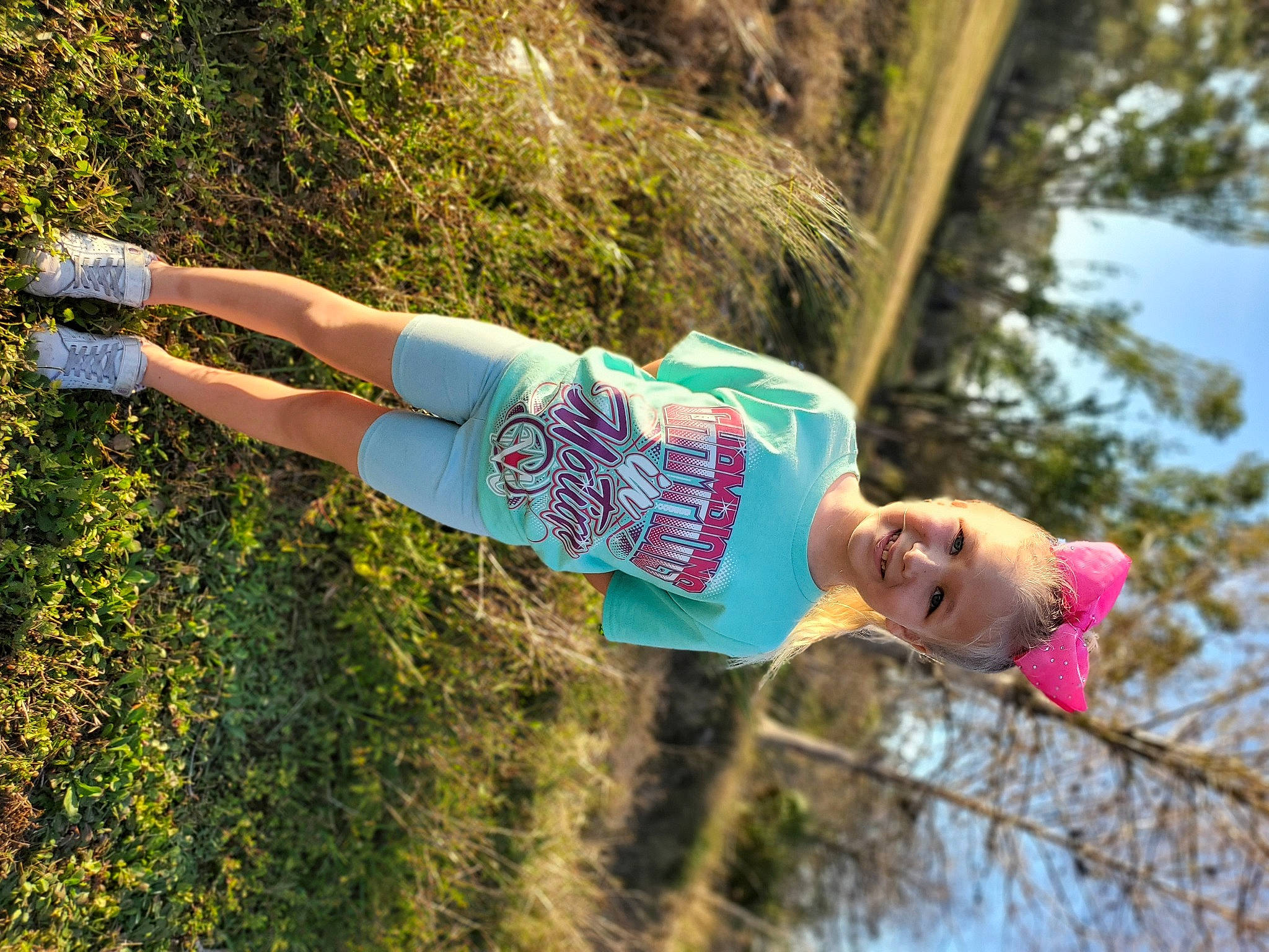 Adasyn is registered to the contest to win money with this photo: adventure, electric_blue, fun, grass, happy, human_leg, joy, leisure, people_in_nature, person, plant, recreation, smile, t_shirt, thigh, tree, vacation, water, wood