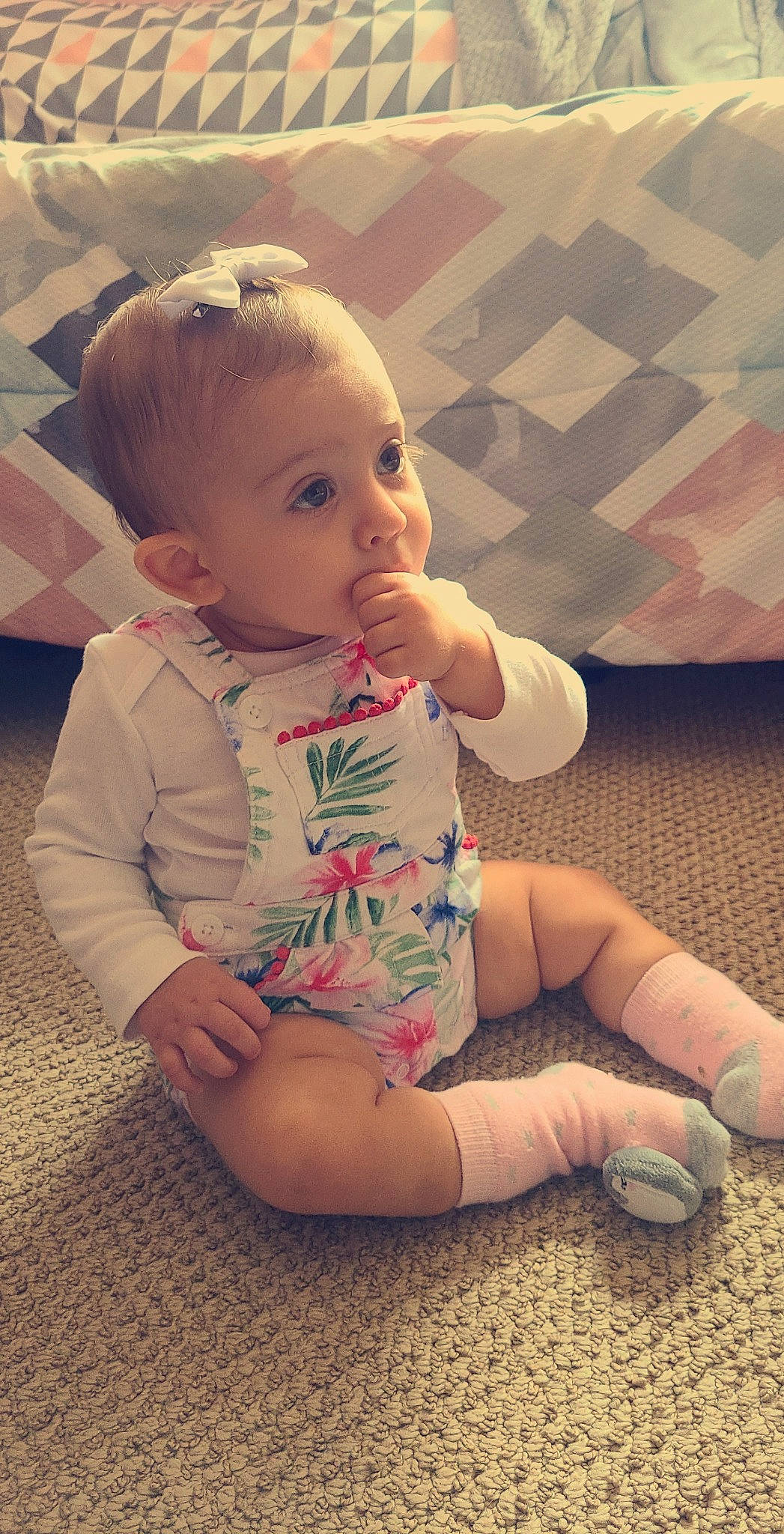 Calliope is registered to the contest to win money with this photo: arm, baby, baby_toddler_clothing, cheek, child, face, finger, head, leg, lip, mouth, person, pink, play, sitting, skin, surprise, toddler