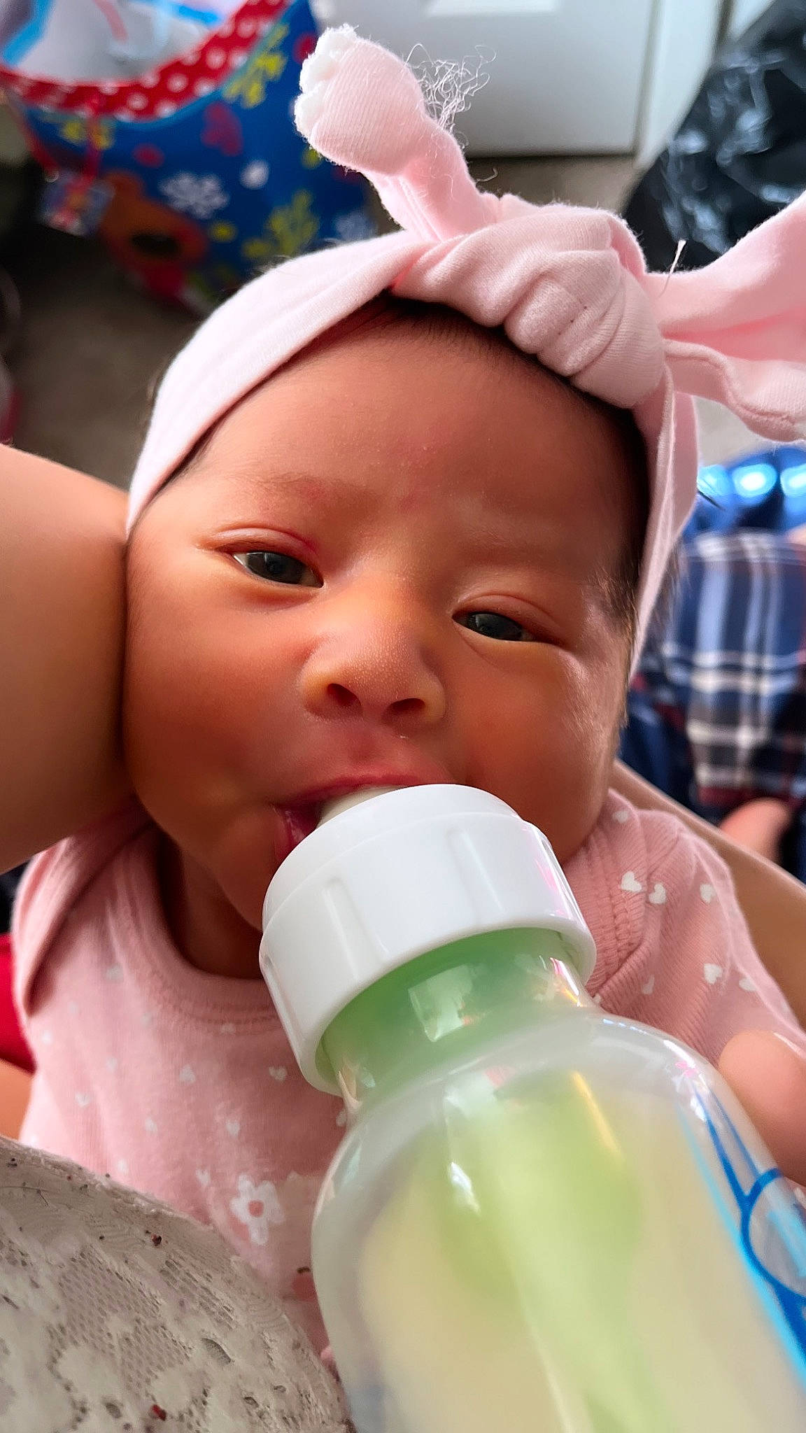 Esme is registered to the contest to win money with this photo: baby, baby_bottle, baby_toddler_clothing, beauty, bottle, cheek, child, drinking, drinkware, eyelash, facial_expression, finger, gesture, happy, headwear, nose, person, plastic_bottle, product, skin