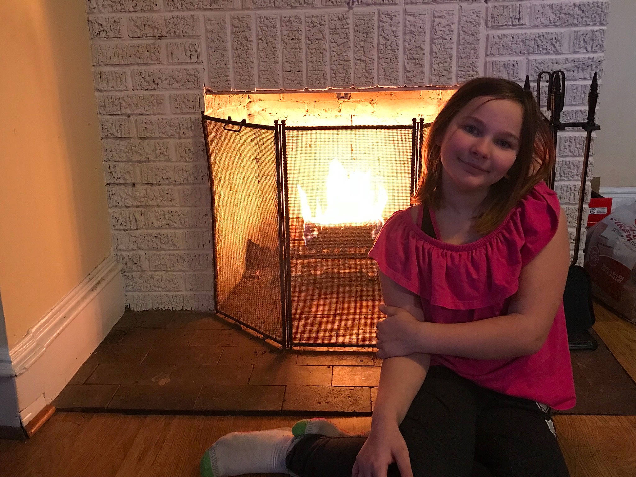 Katelyn is registered to the contest to win money with this photo: fireplace, floor, flooring, heat, joy, long_hair, person, room, shoulder
