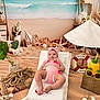 Diana joined the competition — help win amazing prizes! baby, child, infant, pink_swimsuit, headband, towel, seashells, starfish, lifebuoy, beach_theme, indoor, decorations, plants, rope, toy_lighthouse, pineapple_cup, sunglasses, smiling, relaxing, summer