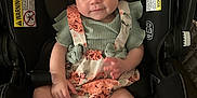 Novalee is registered to the contest to win money with this photo: accessory, baby, car_seat, child, clothing, comfort, cute, fabric, face, headwear, indoor, infant, person, romper, seatbelt, sitting, smile, socks, soft_toy, striped