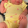 newborn, baby, infant, sleeping, portrait, bow_headband, yellow_outfit, watermelon_pattern, onesie, car_seat, cushion, indoor, close_up, face, hands, feet, peaceful, child, textile, photography
