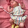baby, newborn, sleeping, infant, portrait, pink, hat, headband, bow, striped_clothing, romper, socks, yellow_socks, pacifier, blanket, textile, lying_down, peaceful, indoors, closeup