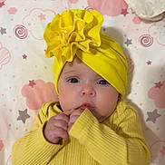 Alana joined the competition — help win amazing prizes! baby, infant, yellow_clothing, headwrap, blanket, stars, pink, gray, soft_toy, cute, lying_down, indoors, child, newborn, face, hands, expression, cozy, pattern, fabric