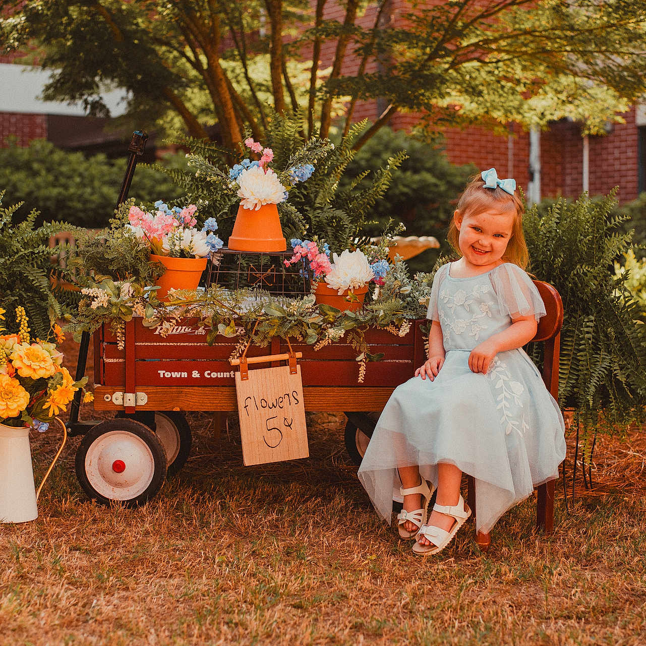 Gracelyn joined the competition — help win amazing prizes! bow, chair, child, dress, flower, garden, girl, grass, greenery, happy, nature, outdoor, plants, portrait, potted_plants, shoes, smile, summer, sunlight, wagon