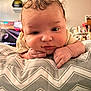 Zaiden joined the competition — help win amazing prizes! baby, infant, face, hands, pillow, pattern, indoor, curly_hair, resting, close_up, cute, child, soft_lighting, expression, person, blanket, home, cozy, portrait, young