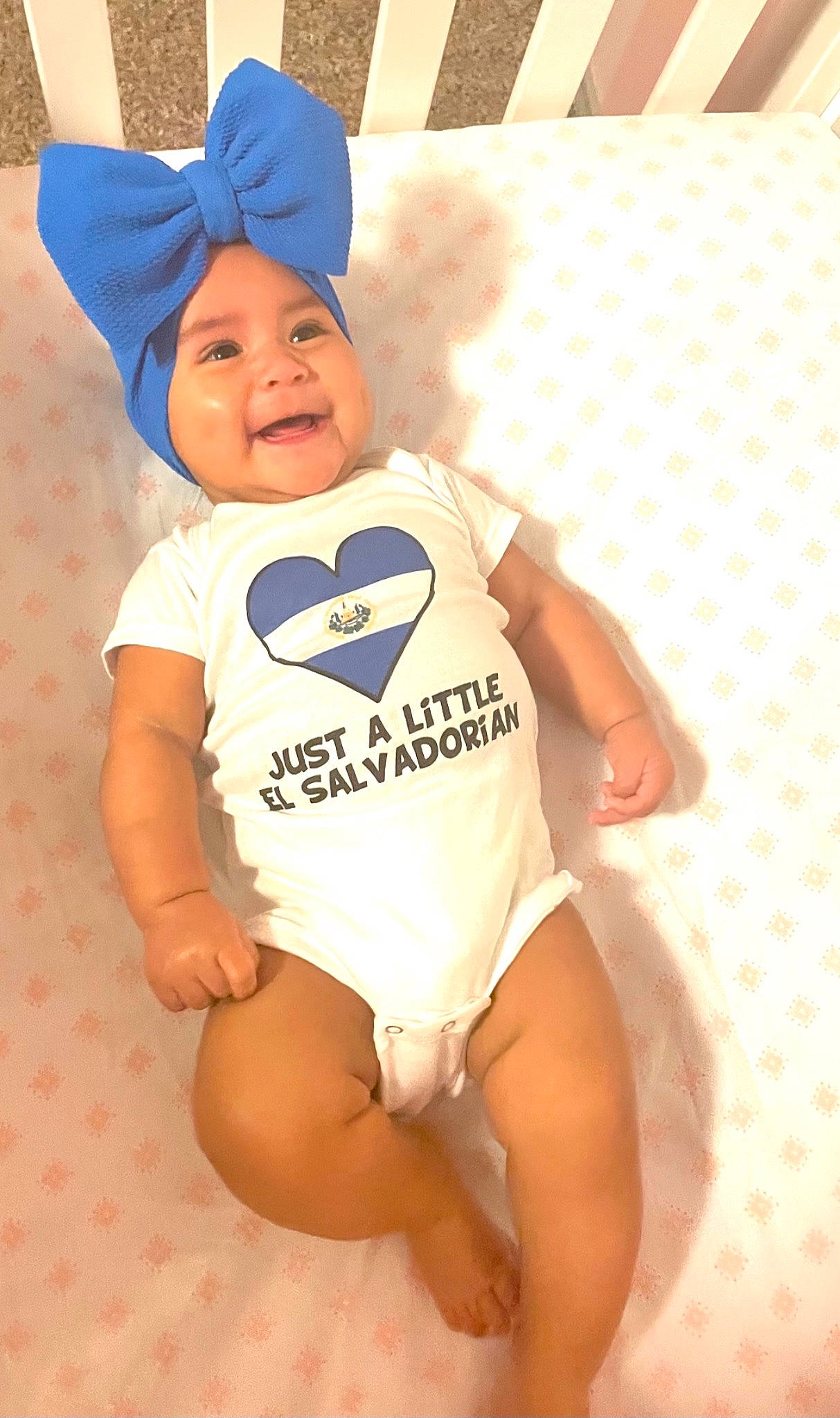 Montserrat is registered to the contest to win money with this photo: baby, baby_toddler_clothing, child, elbow, electric_blue, fun, happy, hat, headgear, headwear, human_body, human_leg, joy, knee, pattern, person, sleeve, smile, sportswear, t_shirt