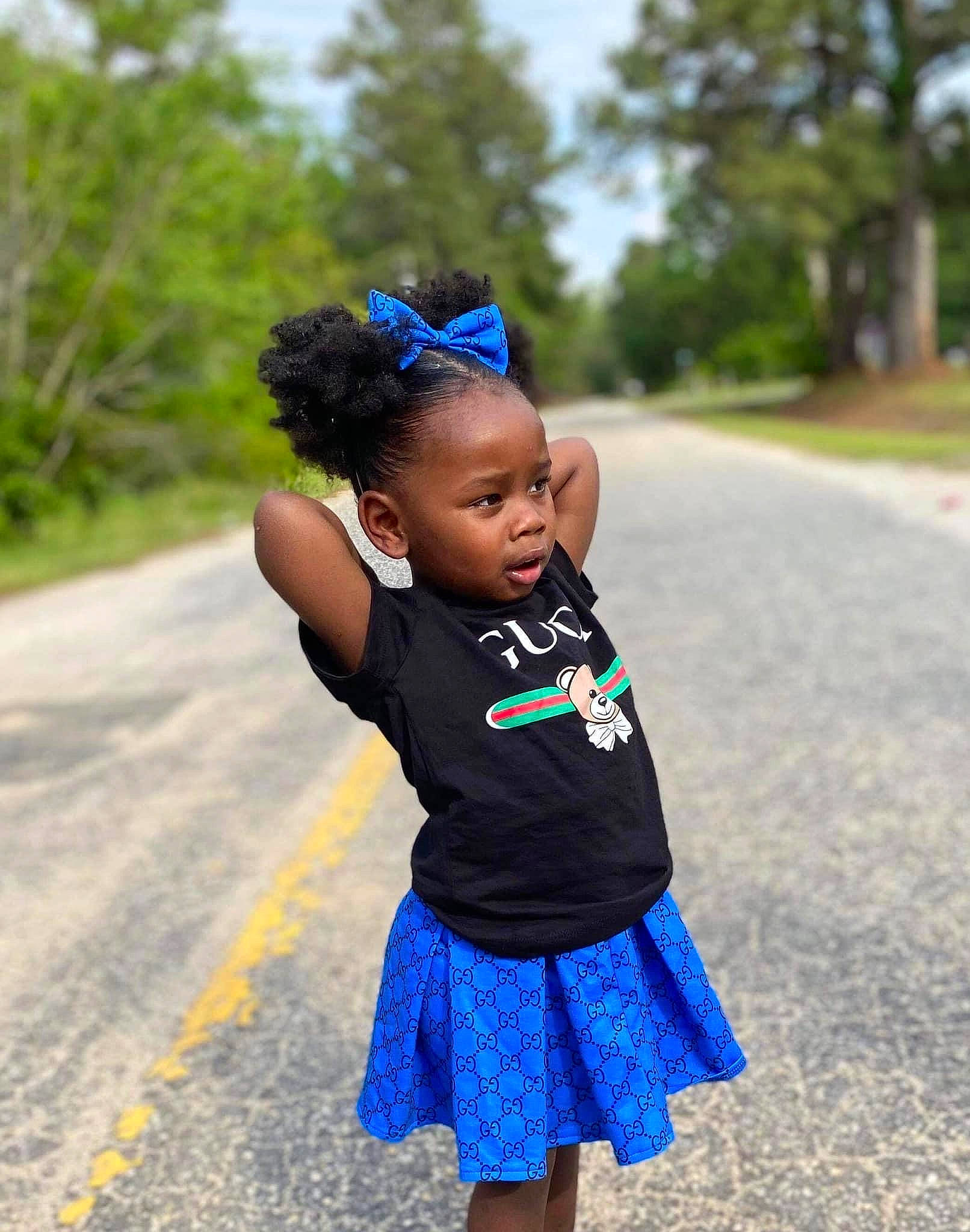 Serenity is registered to the contest to win money with this photo: asphalt, baby_toddler_clothing, child, electric_blue, eye, face, fashion_accessory, fun, grass, hair_accessory, happy, headband, jewellery, pattern, person, plant, recreation, road, toddler, tree