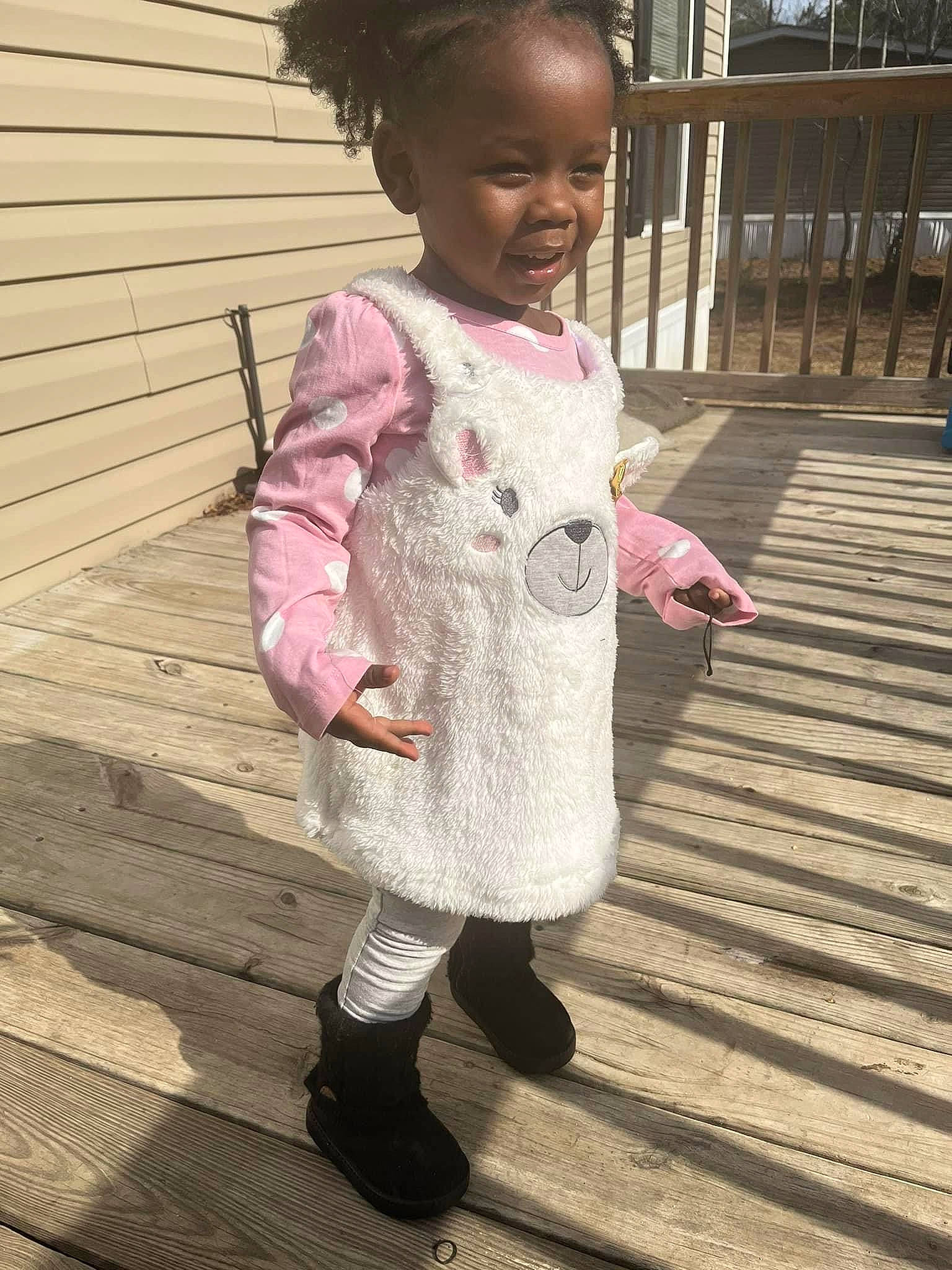 Serenity is registered to the contest to win money with this photo: baby, baby_toddler_clothing, child, dress, face, fun, fur, grass, hand, happy, magenta, pattern, person, pink, sitting, skin, sleeve, smile, sock, toddler