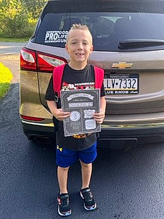 Caiden is registered to the contest to win money with this photo: auto_part, automotive_design, automotive_exterior, automotive_lighting, automotive_tail_brake_light, automotive_tire, automotive_wheel_system, bumper, car, grille, joy, land_vehicle, motor_vehicle, parking, person, plant, shorts, smile, trunk, vehicle