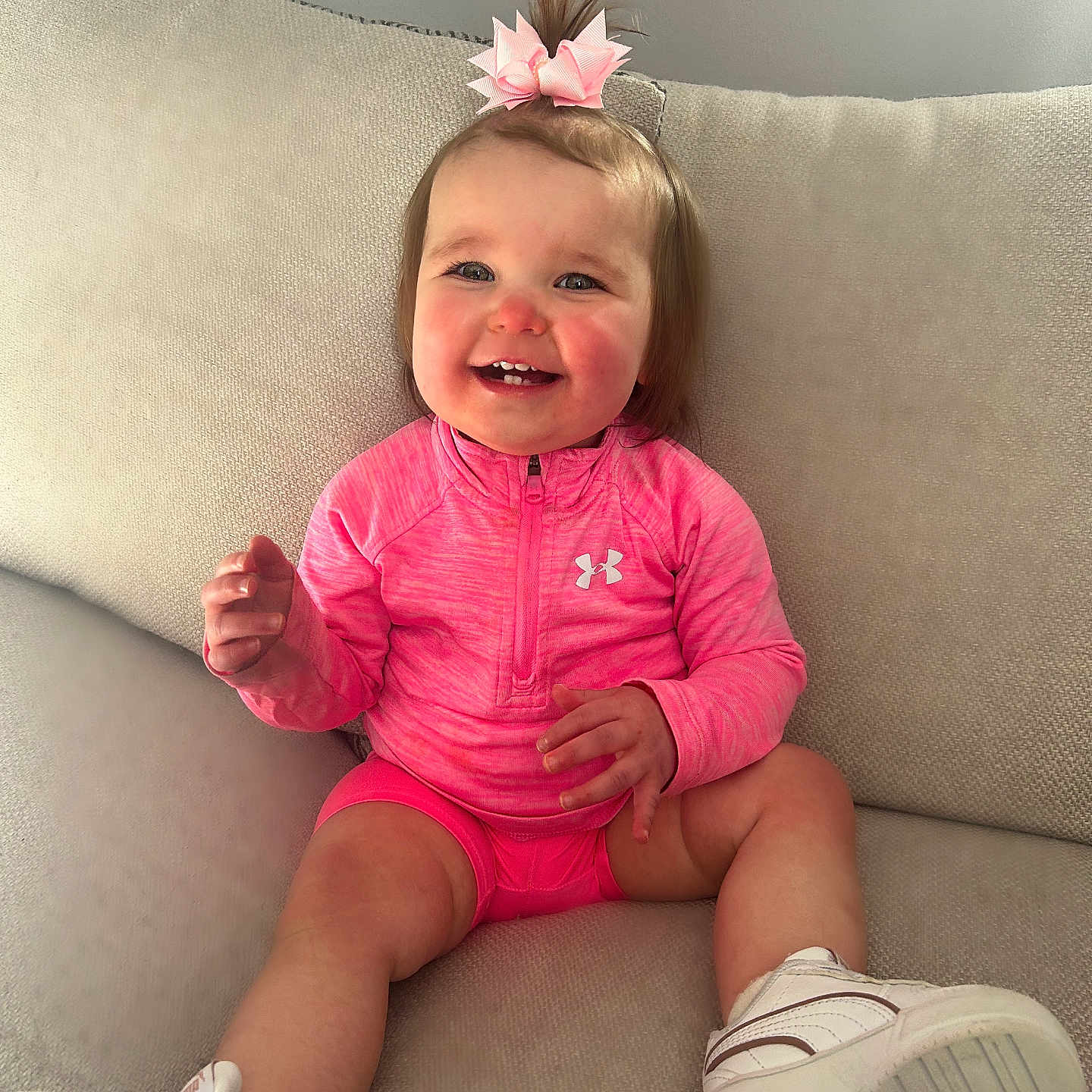 Willow is registered to the contest to win money with this photo: baby, bodypart, clothing, couch, cushion, face, finger, footwear, furniture, hand, happy, head, homedecor, person, photography, portrait, shoe, shorts, sitting, sneaker