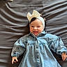 Catalia a rejoint le concours — aidez-le/la à gagner de superbes lots ! baby, bedspread, bow, buttoned_dress, child, cozy, cute, dark_hair, denim_dress, fabric, happy, headband, indoor, infant, lying_down, portrait, small_hands, smile, soft_lighting, white_tights