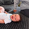 Lucas is registered to the contest to win money with this photo: baby, child, infant, smiling, happy, lying_down, portrait, face, person, adult, sofa, couch, cushion, living_room, indoor, clothing, onesie, family, parent, photography