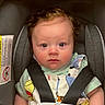 baby, infant, child, car_seat, harness, safety, portrait, face, eyes, looking_at_camera, serious_expression, seated, indoors, vehicle, colorful_clothing, short_sleeves, padded_seat, photography, close_up, safe