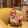 baby, child, thumb_sucking, chair, leather, indoor, person, foot, holding, relaxed, furniture, home, couch, seated, casual, infant, cute, portrait, skin, clothing