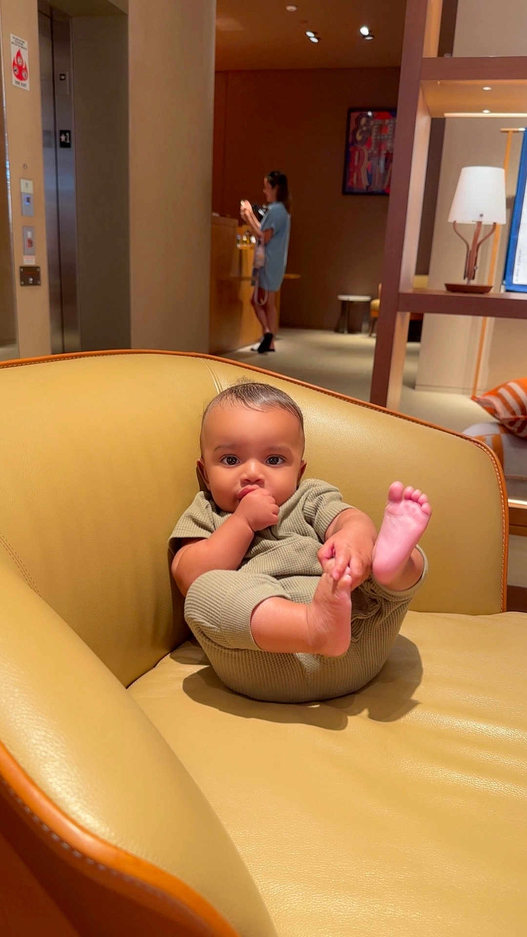 Royal is registered to the contest to win money with this photo: baby, child, thumb_sucking, chair, leather, indoor, person, foot, holding, relaxed, furniture, home, couch, seated, casual, infant, cute, portrait, skin, clothing