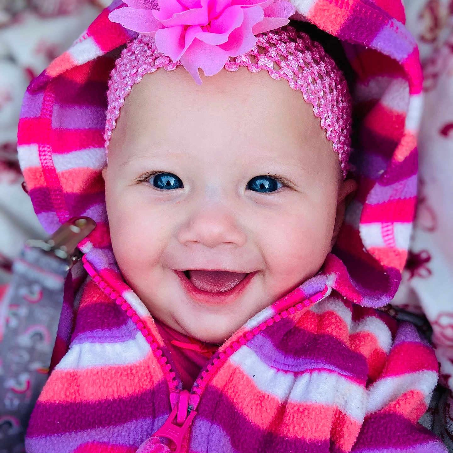 Zia is registered to the contest to win money with this photo: accessories, baby, babylaughing, bonnet, cap, clothing, coat, face, happy, hat, head, headband, hood, jacket, laughing, person, photography, portrait, purple, smile