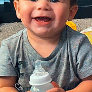 Symere joined the competition — help win amazing prizes! baby, baby_bottle, bottle, carpet, casual_clothing, cheerful, child, curly_hair, cute, day_overlay, happy, indoor, milk_bottle, person, portrait, sitting, smiling, time_overlay, toddler, young_child
