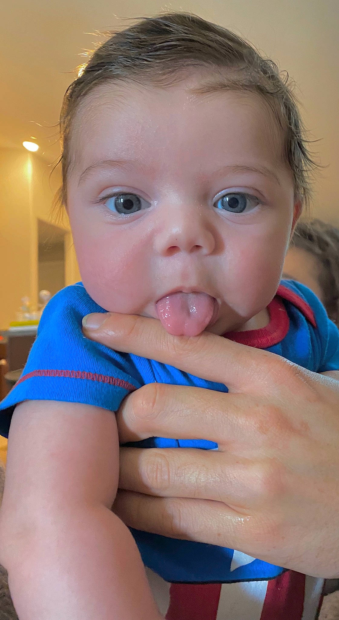 Enzo is registered to the contest to win money with this photo: arm, azure, baby, baby_toddler_clothing, blue, cheek, chin, ear, eyebrow, eyelash, finger, gesture, hand, happy, iris, lip, mouth, neck, nose, person