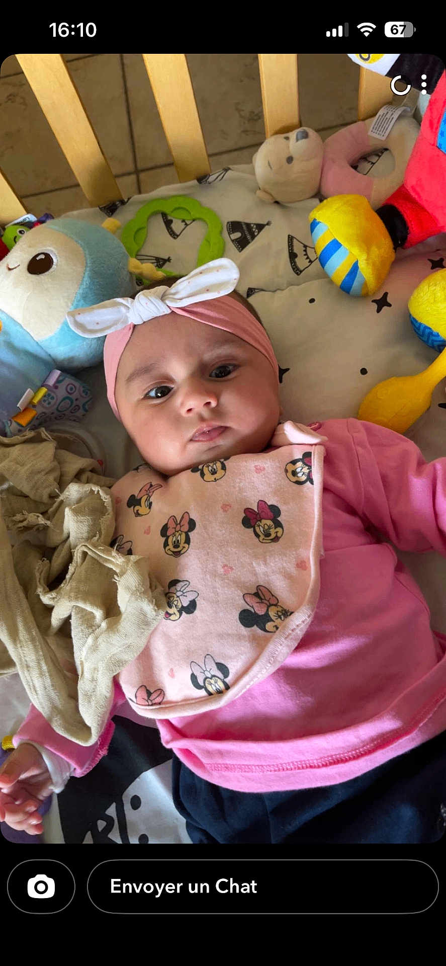 Ynaya participe au concours pour gagner de l'argent avec cette photo : baby, infant, headband, bib, pink_clothing, toy, plush_toy, playmat, face, child, cute, lying_down, indoor, colorful, comfort, soft_toy, pattern, mickey_mouse, expression, curious