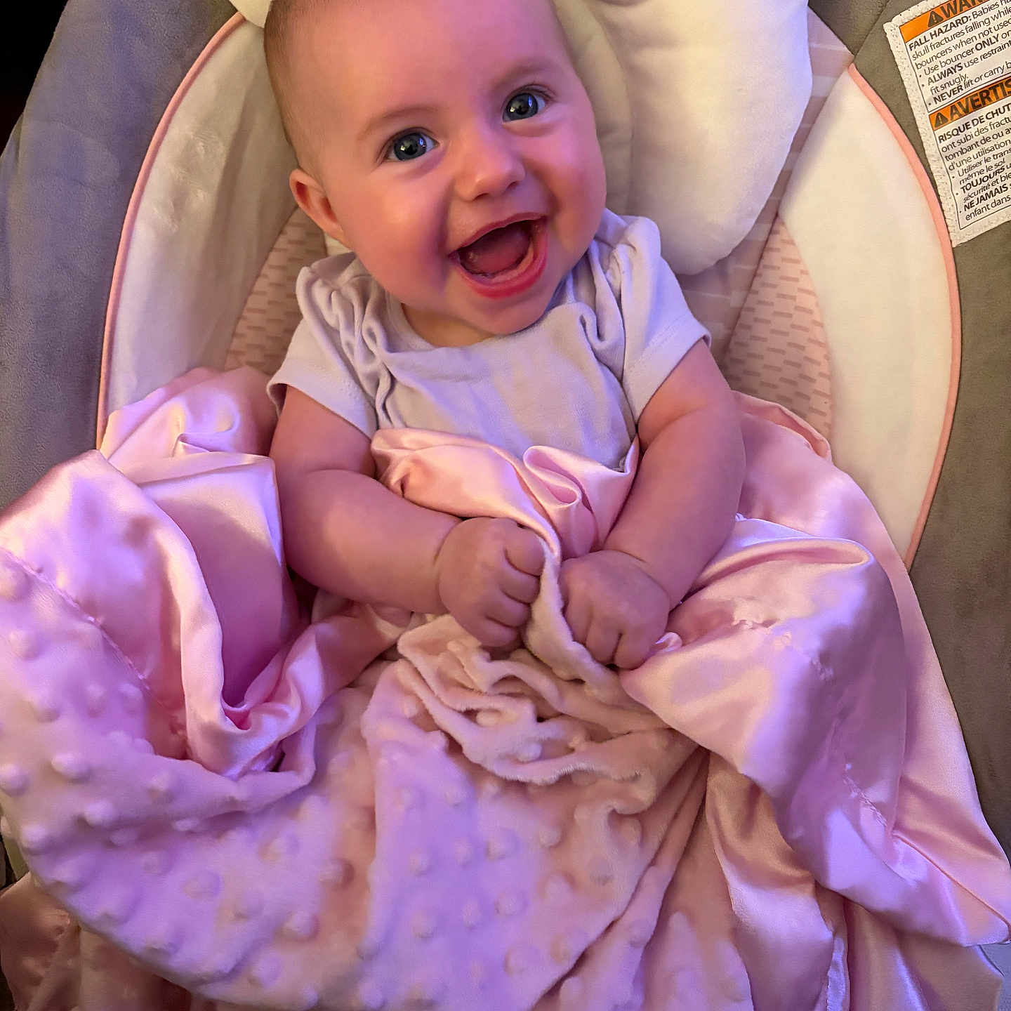 Kinsley is registered to the contest to win money with this photo: baby, smiling, blanket, pink, infant, happy, face, child, cushion, soft, clothing, seat, indoors, cute, portrait, newborn, person, sitting, wrapped, comfort