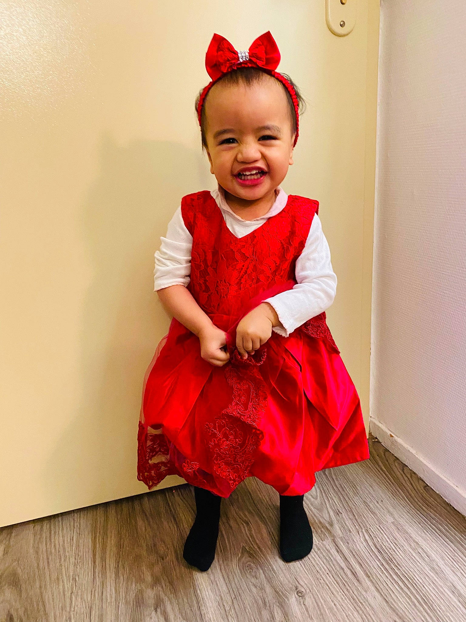 Hilaria participe au concours pour gagner de l'argent avec cette photo : baby, baby_toddler_clothing, costume_hat, day_dress, dress, embellishment, event, flooring, happy, hardwood, hat, joy, laminate_flooring, magenta, one_piece_garment, pattern, person, sleeve, smile, toddler