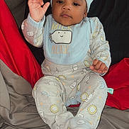 Braylon joined the competition — help win amazing prizes! baby, infant, pajamas, hat, bib, bed, blanket, pillow, smiling, cute, child, indoors, cozy, soft, raising_hand, clothing, portrait, sleepwear, expression, relaxed
