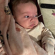 Taïsiana participe au concours pour gagner de l'argent avec cette photo : baby, blanket, cheeks, closeup, couch, cozy, eyes, face, hair, hand, indoor, infant, onesie, pacifier, pink_blanket, plush, portrait, remote_control, sleepy, soft_texture