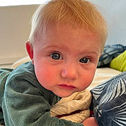 Alice participe au concours pour gagner de l'argent avec cette photo : baby, child, face, blond_hair, blue_eyes, indoor, bed, blanket, pillow, curious, expression, closeup, soft_lighting, toddler, young_child, skin, person, couch, clothing, infant