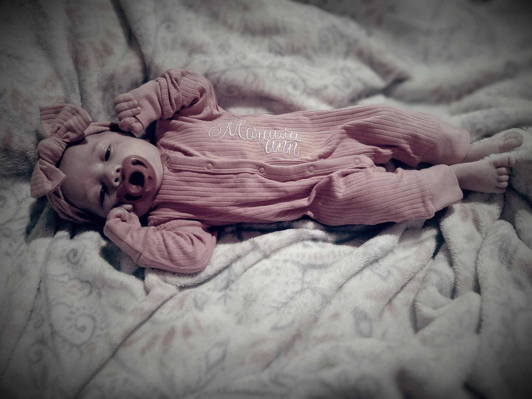 Moravia is registered to the contest to win money with this photo: baby, baby_products, baby_toddler_clothing, bedding, bedtime, child, comfort, darkness, flash_photography, fur, grass, happy, linens, monochrome, monochrome_photography, nap, person, portrait_photography, room, textile