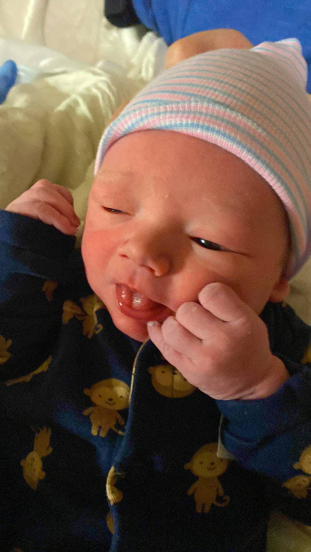 Phoenix is registered to the contest to win money with this photo: baby, baby_toddler_clothing, cheek, child, chin, comfort, eye, finger, gesture, hand, happy, head, headwear, human_body, lip, mouth, nose, person, skin, smile