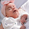 arms, baby, bow, closeup, clothing, cute, floral_pattern, headband, human, infant, newborn, peaceful, person, pink, portrait, resting, sleeping, soft_light, toddler, white