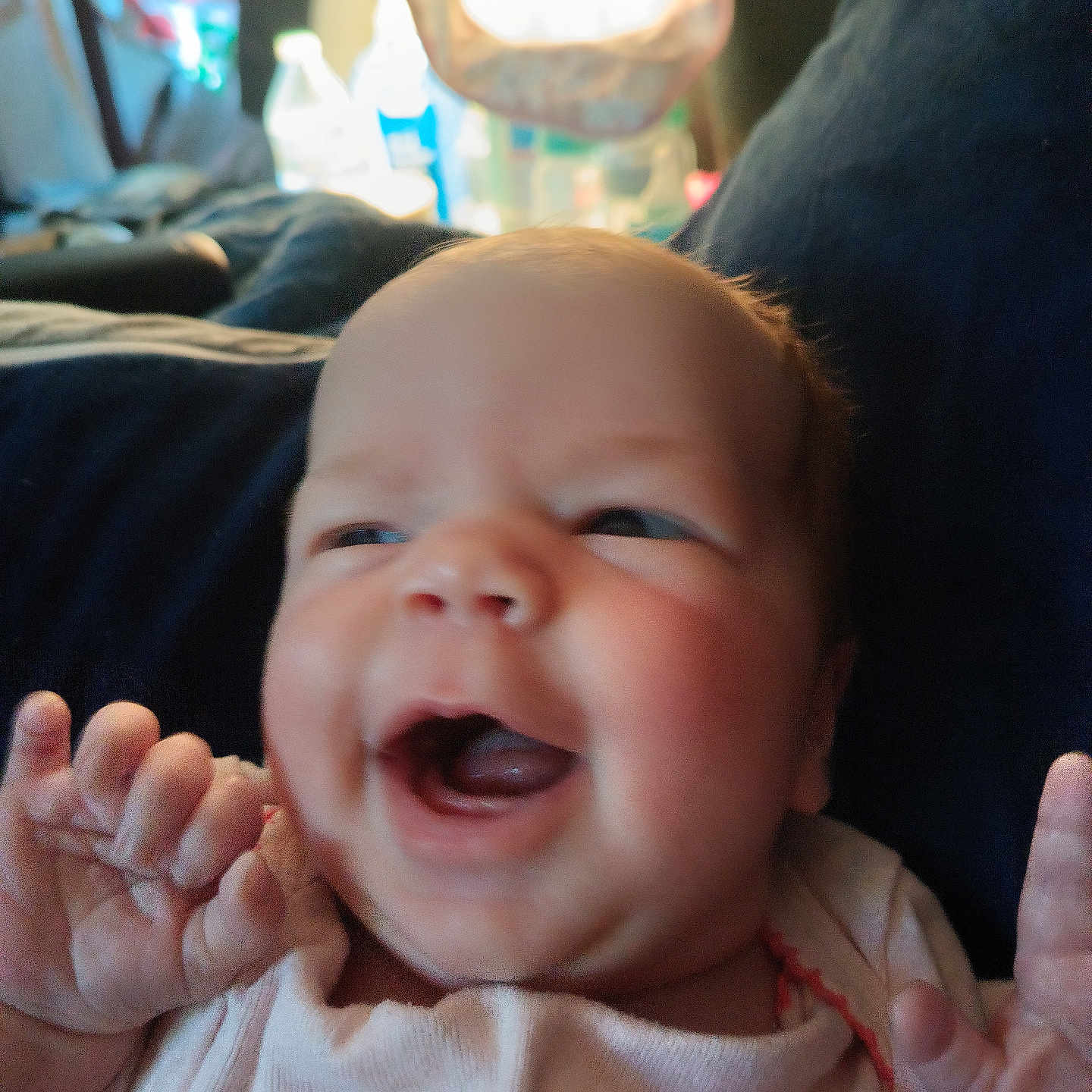 Emeri joined the competition — help win amazing prizes! baby, background, child, clothing, cushion, cute, expression, face, hands, happy, head, indoor, infant, light, mouth, newborn, person, portrait, skin, smiling