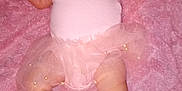 Isabelle is registered to the contest to win money with this photo: baby, infant, pink_clothing, headband, tutu, blanket, soft_texture, lying_down, cute, child, newborn, feet, arms, portrait, indoors, small_person, baby_girl, headwear, fabric, skin